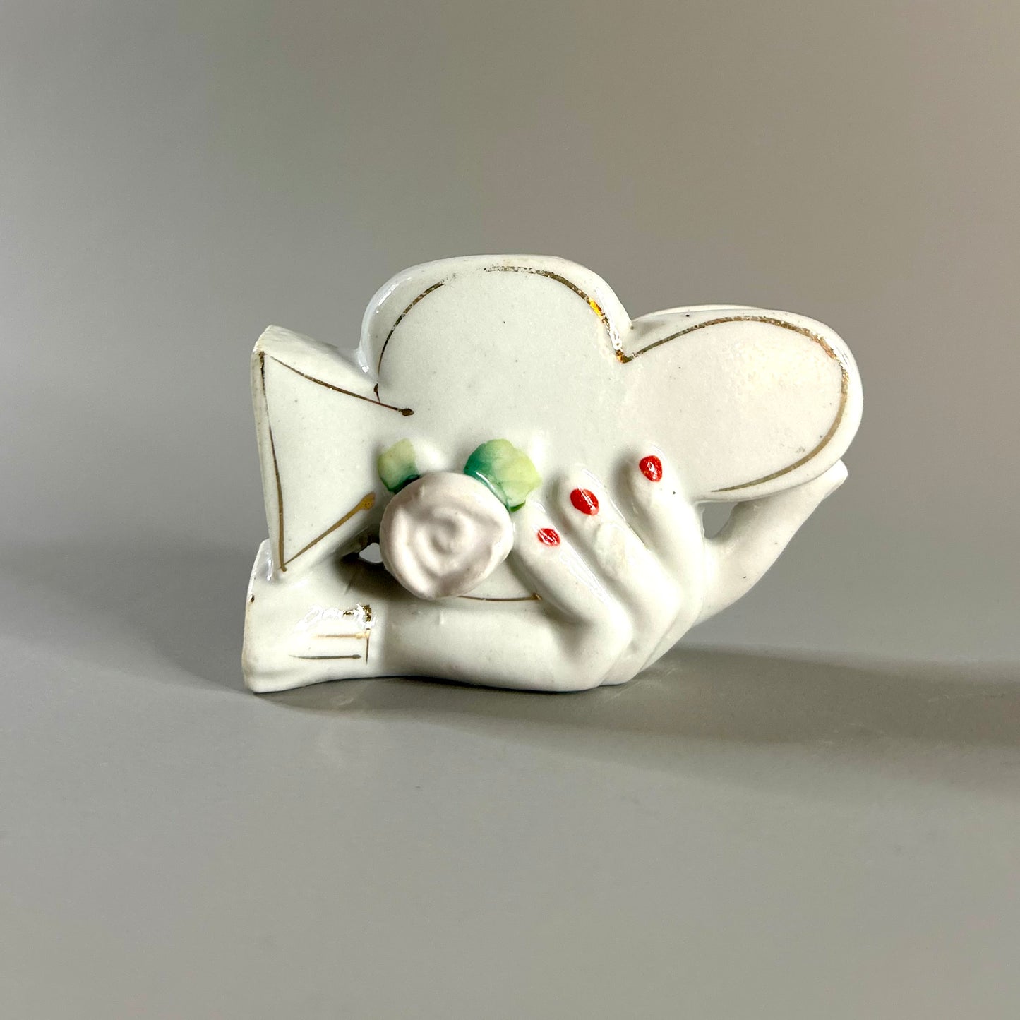 Hand holding club vase