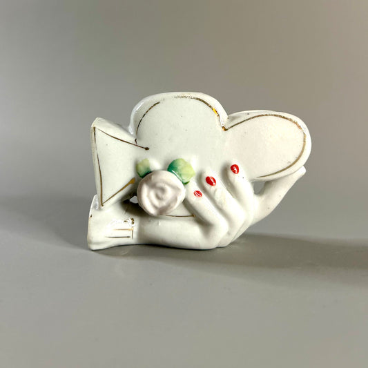 Hand holding club vase