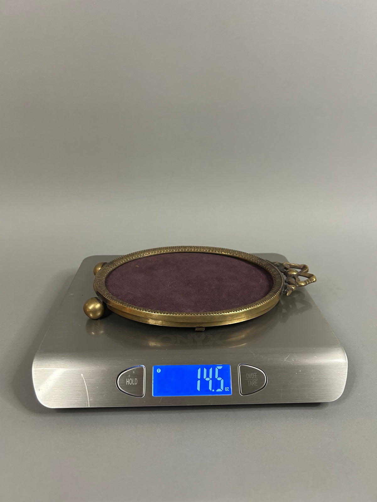 Brass bow oval frame