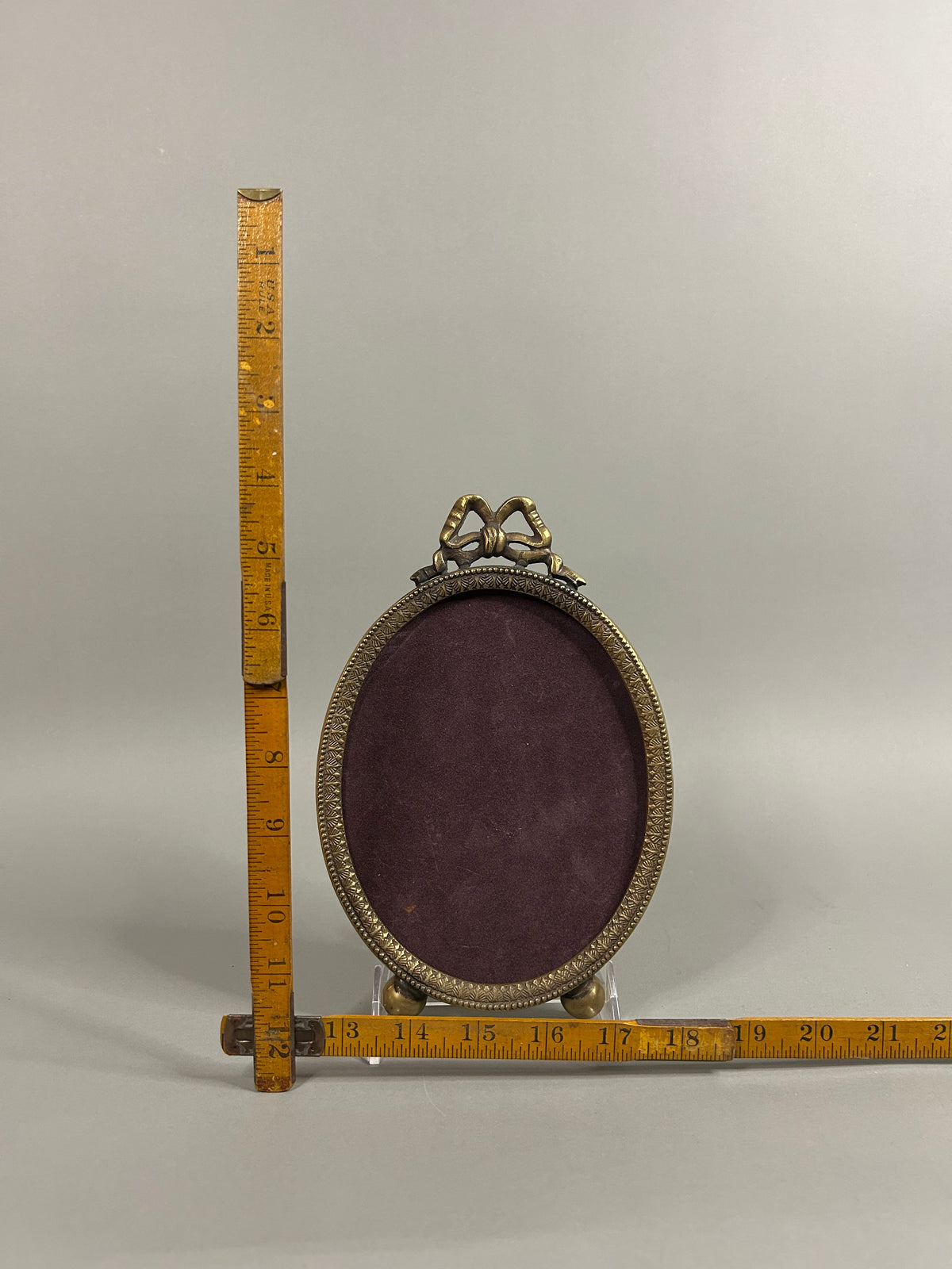 Brass bow oval frame