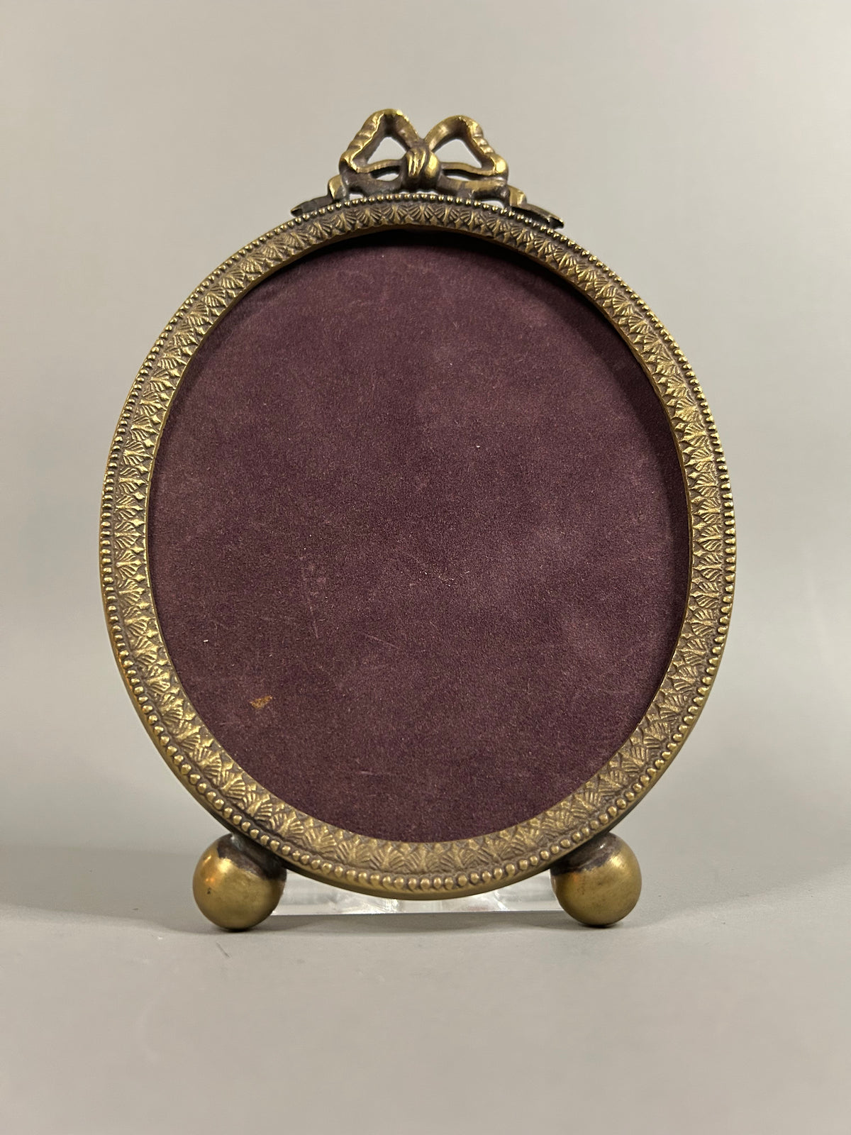 Brass bow oval frame